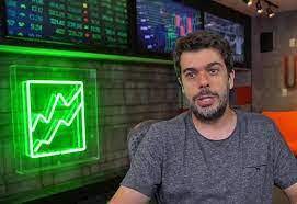 Simon Paleta Trader Tec: Close-up de um trader analisando gráficos financeiros em um monitor de alta tecnologia, com gráficos e indicadores em destaque.